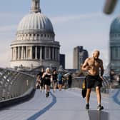 Pesestrians walk along The Millennium Bridge away from St Paul's Cathedral as temperatures are expected to again be high in London.