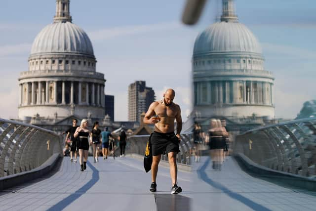 Pesestrians walk along The Millennium Bridge away from St Paul's Cathedral as temperatures are expected to again be high in London.