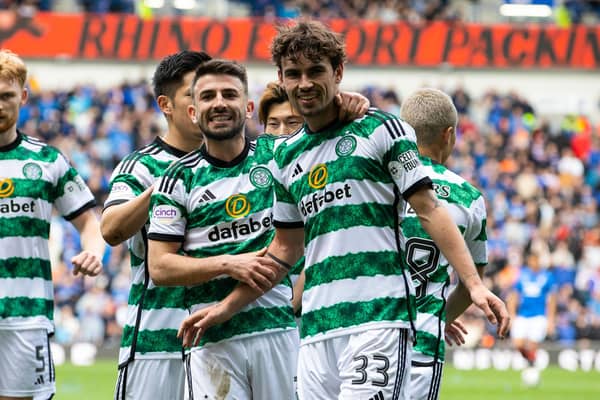 GLASGOW, SCOTLAND - APRIL 07: Celtic's Matt O'Riley (R) celebrates with Greg Taylor as he scores to make it 2-0 during a cinch Premiership match between Rangers and Celtic at Ibrox Stadium, on April 07, 2024, in Glasgow, Scotland. (Photo by Alan Harvey / SNS Group)
