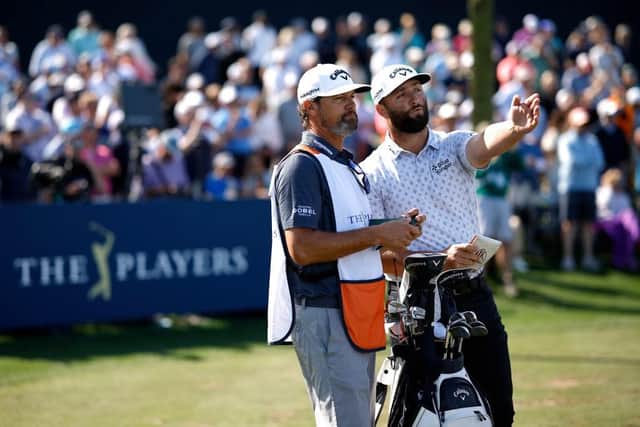 Jon Rahm talks with caddie Adam Hayes during the opening round of The Players Championship before withdrawing from the second round at TPC Sawgrass in Florida due to illness. Picture: Jared C. Tilton/Getty Images.