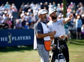 Jon Rahm talks with caddie Adam Hayes during the opening round of The Players Championship before withdrawing from the second round at TPC Sawgrass in Florida due to illness. Picture: Jared C. Tilton/Getty Images.