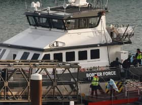 Migrants picked up at sea while attempting to cross the English Channel are escorted off from a UK Border Force boat upon arrival at the Marina in Dover, southeast England, last year.