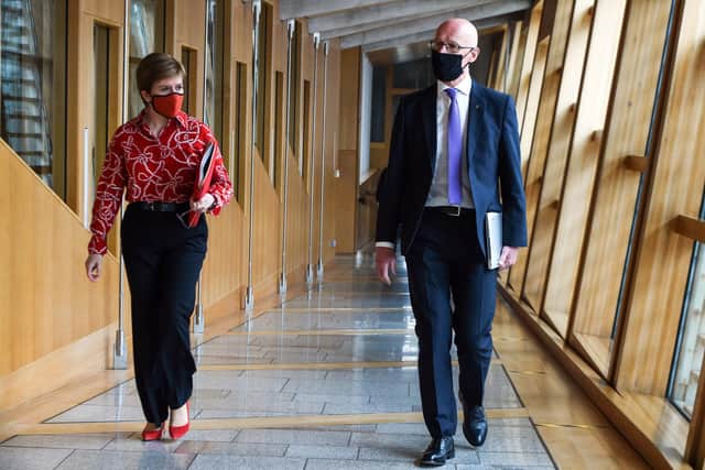 SNP leader Nicola Sturgeon arrives at Holyrood with Deputy First Minister John Swinney. Picture: Andy Buchanan/PA Wire