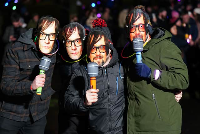Revellers wear Jarvis Cocker masks ahead of Pulp's headline appearance at Edinburgh's Hogmanay celebrations. Picture: Jane Barlow/PA Wire