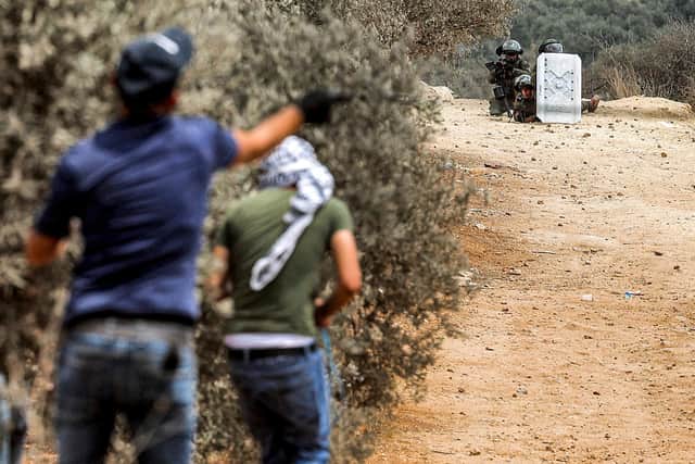 Palestinian protesters confront Israeli forces in the town of Beita, near the occupied West Bank city of Nablus (Picture: Jaafar Ashtiyeh/AFP via Getty Images)