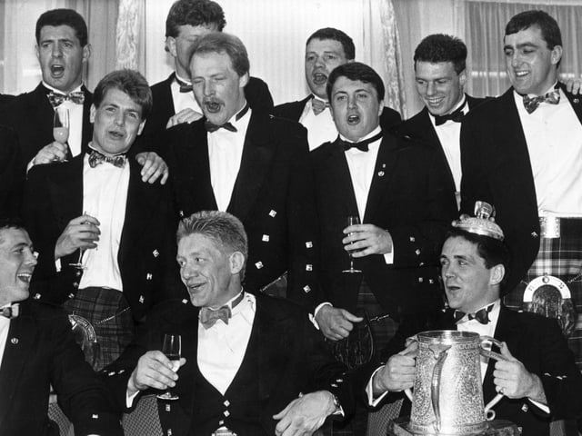 John Jeffrey and the rest of the Scottish team including Scott Hastings (l) and David Sole (r) celebrate with the Calcutta Cup after beating England.
