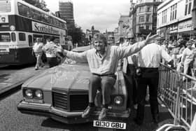 British businessman Richard Branson poses with his pink Pontiac car outside his new Virgin Megastore, opening in Edinburgh in July 1990.