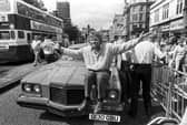 British businessman Richard Branson poses with his pink Pontiac car outside his new Virgin Megastore, opening in Edinburgh in July 1990.
