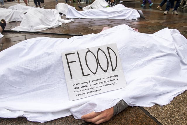 Shoppers will have the chance to stop to read the placards laid out on the ‘bodies’ with the ‘cause of death’ including 'Heat Stress - Death from temperature rising to over 40 degrees' and 'Famine - starvaton caused by crop failure'.
