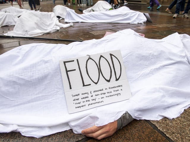 Shoppers will have the chance to stop to read the placards laid out on the ‘bodies’ with the ‘cause of death’ including 'Heat Stress - Death from temperature rising to over 40 degrees' and 'Famine - starvaton caused by crop failure'.