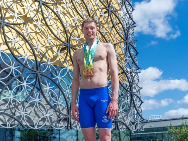Duncan Scott of Team Scotland shows off his medals. He won two golds and three bronze medals in the pool to become Scotland's all-time most decorated Games competitor.