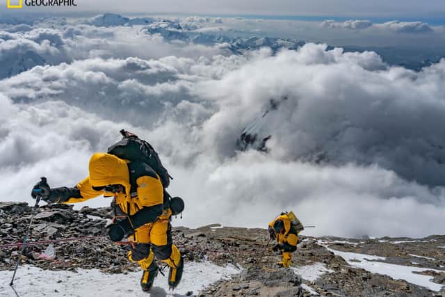 Sucking deeply on their oxygen masks in the thin air of the Death Zone, Matthew Irving (left) and Mark Synnott follow a fixed line to the Northeast Ridge at an elevation of about 27,000 feet — higher than all but five mountains in the world. PIC: Renan Ozturk/National Geographic