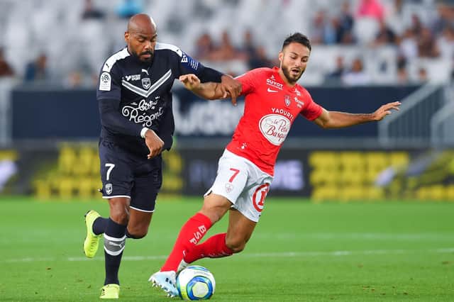 Haris Belkebla (right) shields the ball from Bordeaux forward Jimmy Briand during a Ligue 1 match in September 2019