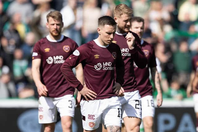 The Hearts players look dejected after their defeat by Hibs at Easter Road.