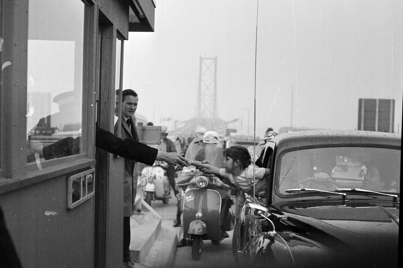 Forth Road Bridge is officially opened in September 1964 - Donna Morrison of Broughty Ferry pays her 2/6 toll.
