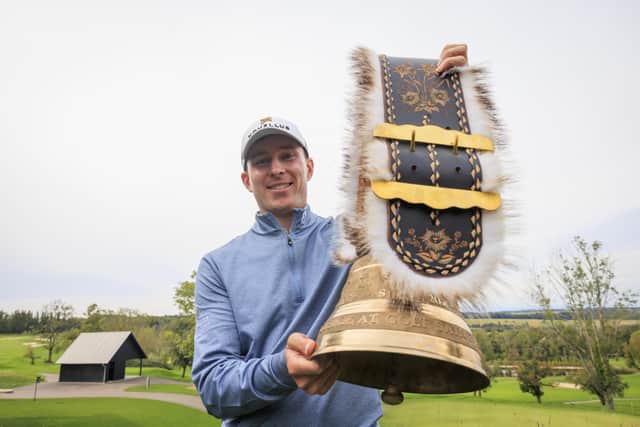 Euan Walker shows off the cow bell trophy after landing his weekend win in the Swiss Challenge at Golf Saint Apollinaire in Folgensbourg, France. Picture: Jan Hetfleisch/Getty Images.