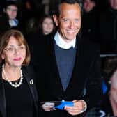 (FILE PHOTO) Actor Richard E Grant has paid tribute to his wife of 35 years Joan Washington in a heartfelt message on social media after she reportedly died last night. British actor Richard E Grant (R) poses with his wife Joan Washington (L) on the blue carpet as she arrives to attend the European premiere of the film "The Iron Lady" at BFI Southbank in London on January 4, 2012. The biopic set in the present day is a story of ambition; power won and power lost; and also love, with flashes of memory whisking the viewer off to a time when Margaret Thatcher, played by Meryl Streep, was the Western world's first female leader and possibly Britain's most divisive prime minister.   AFP PHOTO / LEON NEAL (Photo credit should read LEON NEAL/AFP via Getty Images)