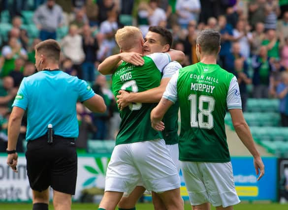 Kyle Magennis embraces Josh Doig after the left-back set him up for Hibs' second goal against Ross County.