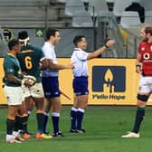 Australian referee Nic Berry, with arm raised, and his assistant Ben O'Keeffe, from New Zealand, speak to Lions captain Alun Wyn Jones during the first Test against South Africa. Picture: David Rogers/Getty Images