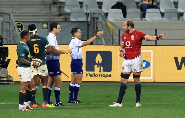 Australian referee Nic Berry, with arm raised, and his assistant Ben O'Keeffe, from New Zealand, speak to Lions captain Alun Wyn Jones during the first Test against South Africa. Picture: David Rogers/Getty Images