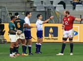 Australian referee Nic Berry, with arm raised, and his assistant Ben O'Keeffe, from New Zealand, speak to Lions captain Alun Wyn Jones during the first Test against South Africa. Picture: David Rogers/Getty Images