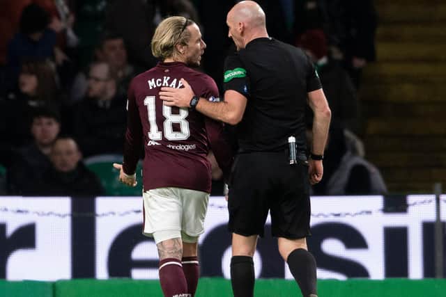 Referee Bobby Madden with Hearts winger Barrie McKay after he is hit with objects from the Celtic support last Thursday.