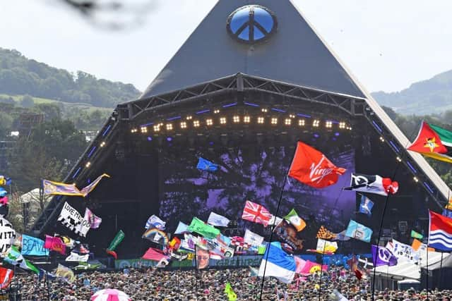 Festivalgoers watch US legend Diana Ross perform on the Pyramid Stage at the Glastonbury festival near the village of Pilton in Somerset, south-west England, on June 26, 2022.