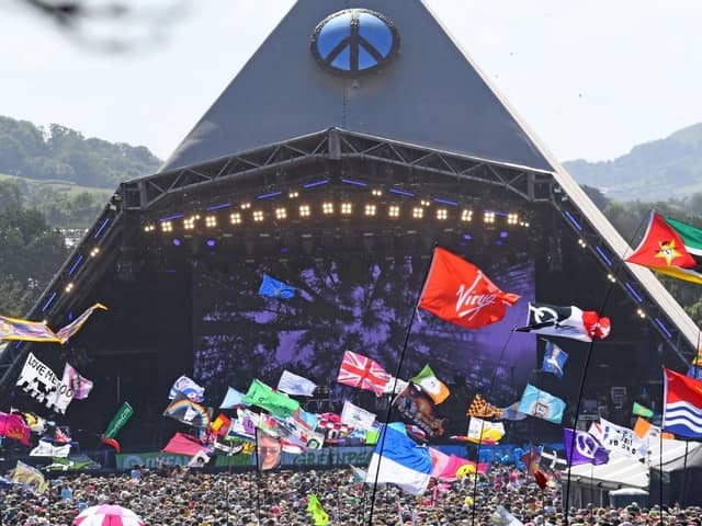 Festivalgoers watch US legend Diana Ross perform on the Pyramid Stage at the Glastonbury festival near the village of Pilton in Somerset, south-west England, on June 26, 2022.