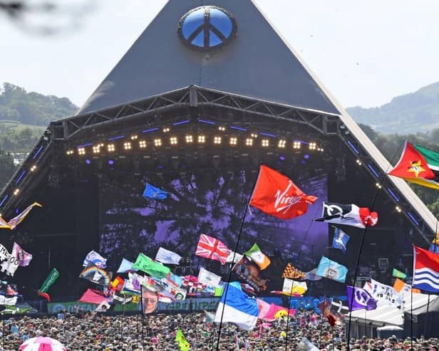 Festivalgoers watch US legend Diana Ross perform on the Pyramid Stage at the Glastonbury festival near the village of Pilton in Somerset, south-west England, on June 26, 2022.