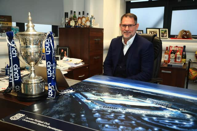 Dundee managing director John Nelms with a render of Dundee’s Camperdown Stadium.