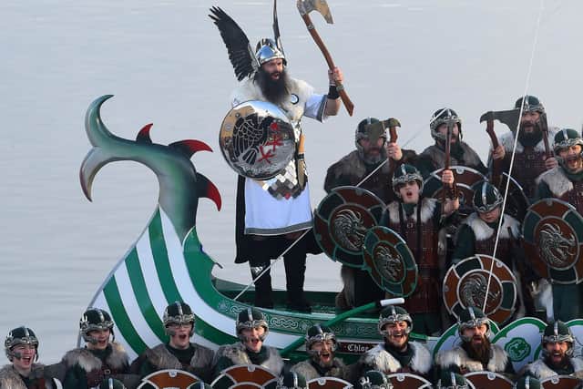 Guizer Jarl, John Nicholson (in white) leads the chants as participants dressed as vikings pose on the viking longboat that will be set alight in Lerwick, Shetland Islands on January 29, 2019 before the Up Helly Aa festival later in the day. Pic: ANDY BUCHANAN/AFP via Getty Images)
