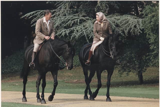 US president Ronald Reagan and the Queen share their love of horses in Windsor Great Park