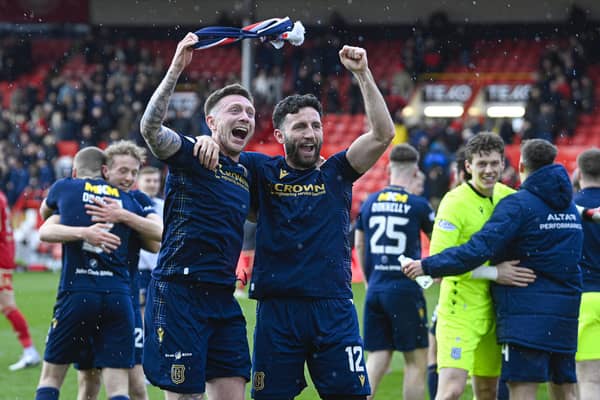 Dundee's Jordan McGhee (L) and Ricki Lamie celebrate securing top six at Pittodrie.