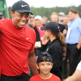 Tiger Woods celebrates his Masters win last year with son Charlie. The pair will play together at the PNC Championship next month. Picture: Andrew Redington/Getty Images