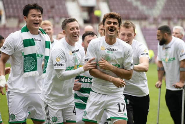 Callum McGregor, centre, enjoys the title celebrations after defeating Hearts 2-0 at Tynecastle.
