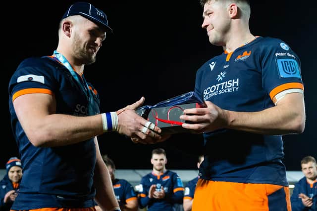 Magnus Bradbury is presented with a cap to mark his 100th Edinburgh appearance by club co-captain Grant Gilchrist after the win over Benetton.  (Photo by Ross Parker / SNS Group)