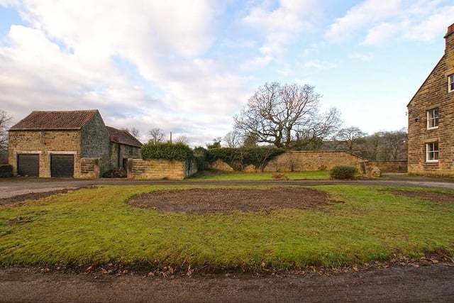 A photo that shows where the stone barn lies in relation to the main house.