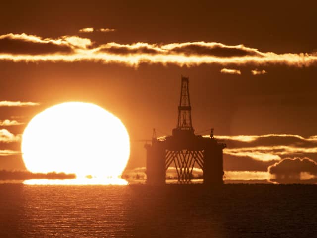 The sun rising behind a redundant oil platform. PIC: Jane Barlow/PA Wire