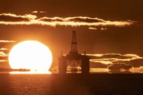 The sun rising behind a redundant oil platform. PIC: Jane Barlow/PA Wire