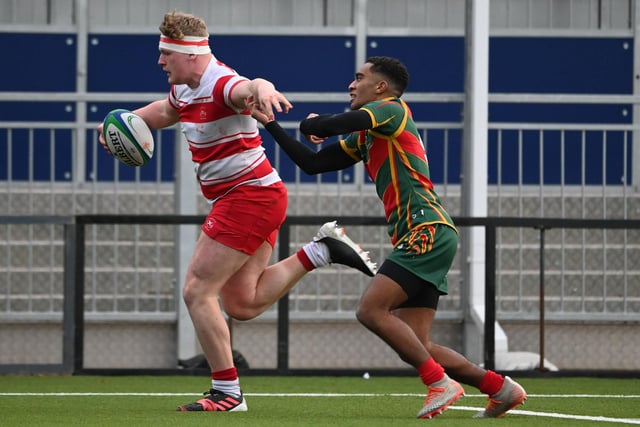 Loretto's Finn Duraj scores a try during the Shield final