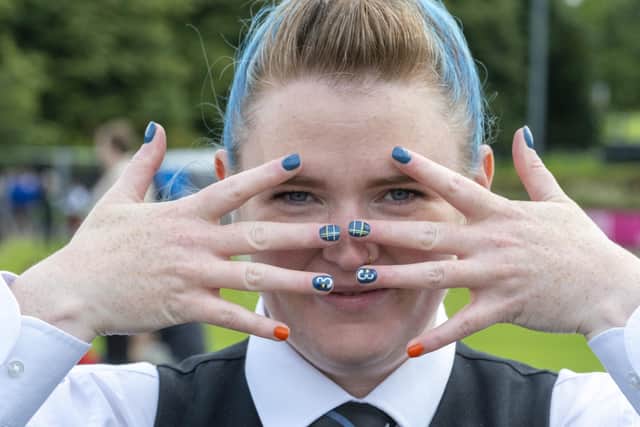 Emma Buchan from the People's Ford Boghall & Bathgate pipeband nails her colours in Battle of the Bagpipes. Picture: Peter Devlin/Sky