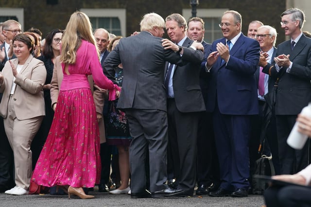It was also atched by Michael Ellis (second right) and Jacob Rees-Mogg (far right). Tory MPs who had gathered to watch Boris Johnson’s farewell speech at Downing Street broke into cheers as he finished his address.

Mr Johnson held his wife’s hand and shook hands with officials as he left the street to rapturous applause.