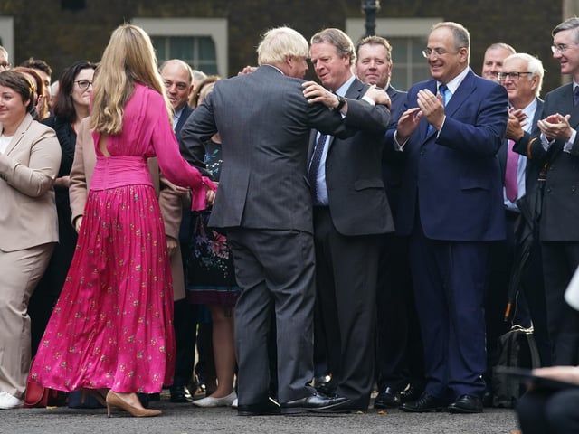 It was also atched by Michael Ellis (second right) and Jacob Rees-Mogg (far right). Tory MPs who had gathered to watch Boris Johnson’s farewell speech at Downing Street broke into cheers as he finished his address.

Mr Johnson held his wife’s hand and shook hands with officials as he left the street to rapturous applause.