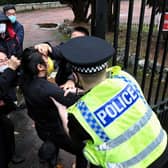 Police try to pull a Hong Kong pro-democracy protester out of the grounds of the Chinese consulate in Manchester. Picture: Matthew Leung/The Chaser News/AFP via Getty Images