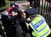 Police try to pull a Hong Kong pro-democracy protester out of the grounds of the Chinese consulate in Manchester. Picture: Matthew Leung/The Chaser News/AFP via Getty Images