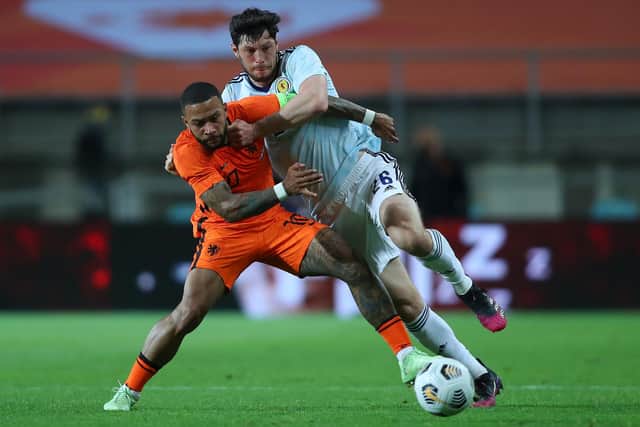 Scotland defender Scott McKenna battles for possesion with Netherlands forward Memphis Depay during the last meeting between the sides in 2021. (Photo by Fran Santiago/Getty Images)