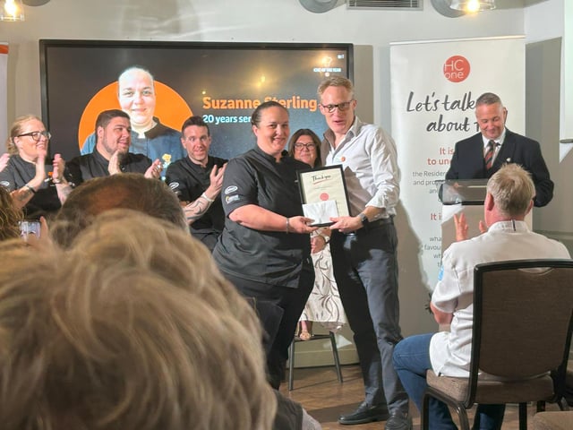 Suzanne Stirling, Group Development Chef at HC-One being presented with her 20 year long service award by James Tugendhat, Chief Executive Officer at HC-One at the HC-One Chef of the Year Competition 2025