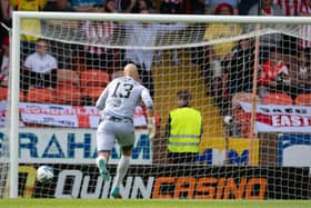 Dundee United's Charlie Mulgrew's back pass goes past Carljohan Eriksson during a pre-season friendly  against Sunderland.