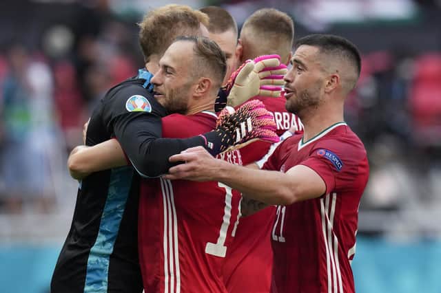 Hungary's Peter Gulacsi, Endre Botka and Attila Szalai celebrate at the end of the Euro 2020 soccer championship group F match between Hungary and France, at the Ferenc Puskas stadium in Budapest, Saturday, June 19, 2021. The match ended in a 1-1 draw. (AP Photo/Darko Bandic)