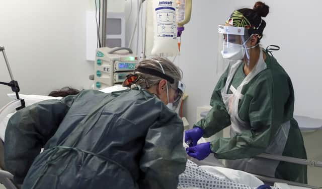 Nurses caring for a patient in an Intensive Care ward.